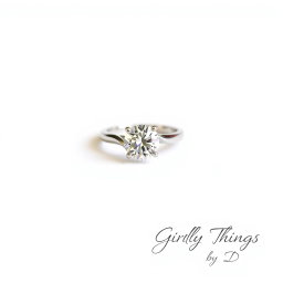 A stunning solitaire diamond ring placed against a clean white background, minimalist and chic design