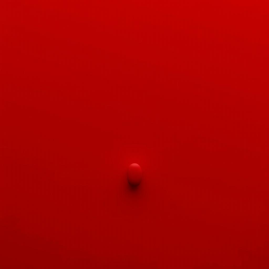 A minimalistic image with a solid dark red background