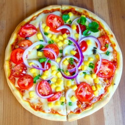 A vibrant and colorful pizza featuring a refreshing combination of crunchy onions, juicy tomatoes, and sweet corn, all generously layered beneath a gooey, melted mozzarella cheese