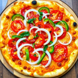 A delicious pizza featuring a zesty medley of fresh, sliced onions, juicy tomatoes, and vibrant capsicum (bell peppers) arranged artfully across the surface