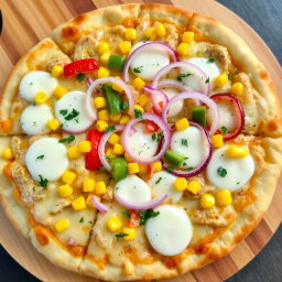 A deliciously crafted pizza featuring a colorful topping of sweet corn, crunchy onions, and fresh capsicum, all harmoniously combined atop a generous layer of melted mozzarella cheese