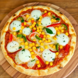 A scrumptious pizza topped with an enticing mix of sweet corn, crunchy onions, and colorful capsicum, all artfully arranged over a generous layer of gooey, melted mozzarella cheese