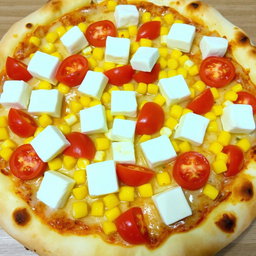 A delicious pizza featuring sweet corn and juicy tomatoes, generously topped with creamy paneer cubes