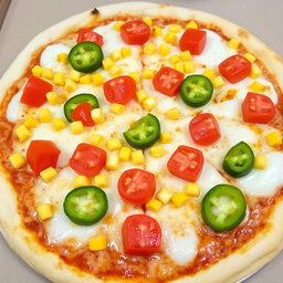 A scrumptious pizza topped with sweet corn and juicy tomatoes, perfectly complemented by fresh green capsicum