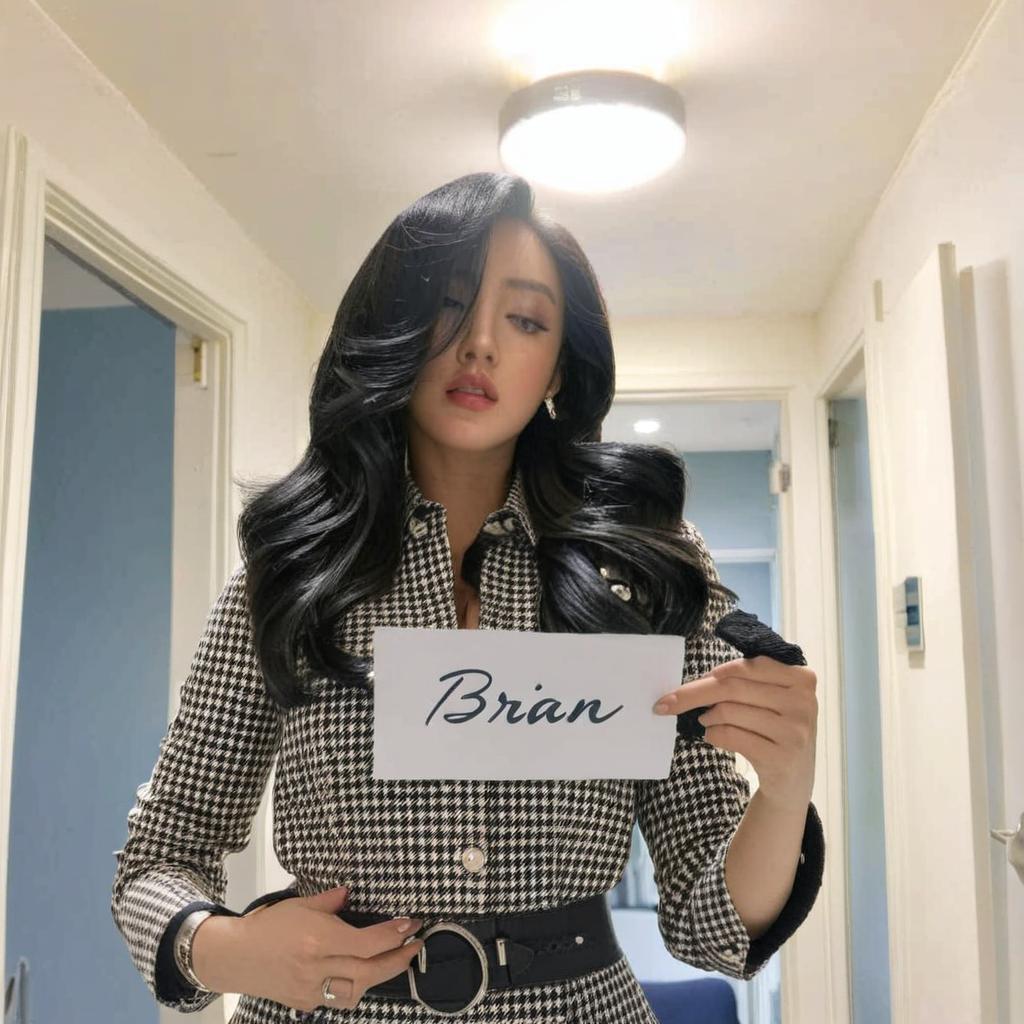 Holding a paper with ''BRIAN'' written on it