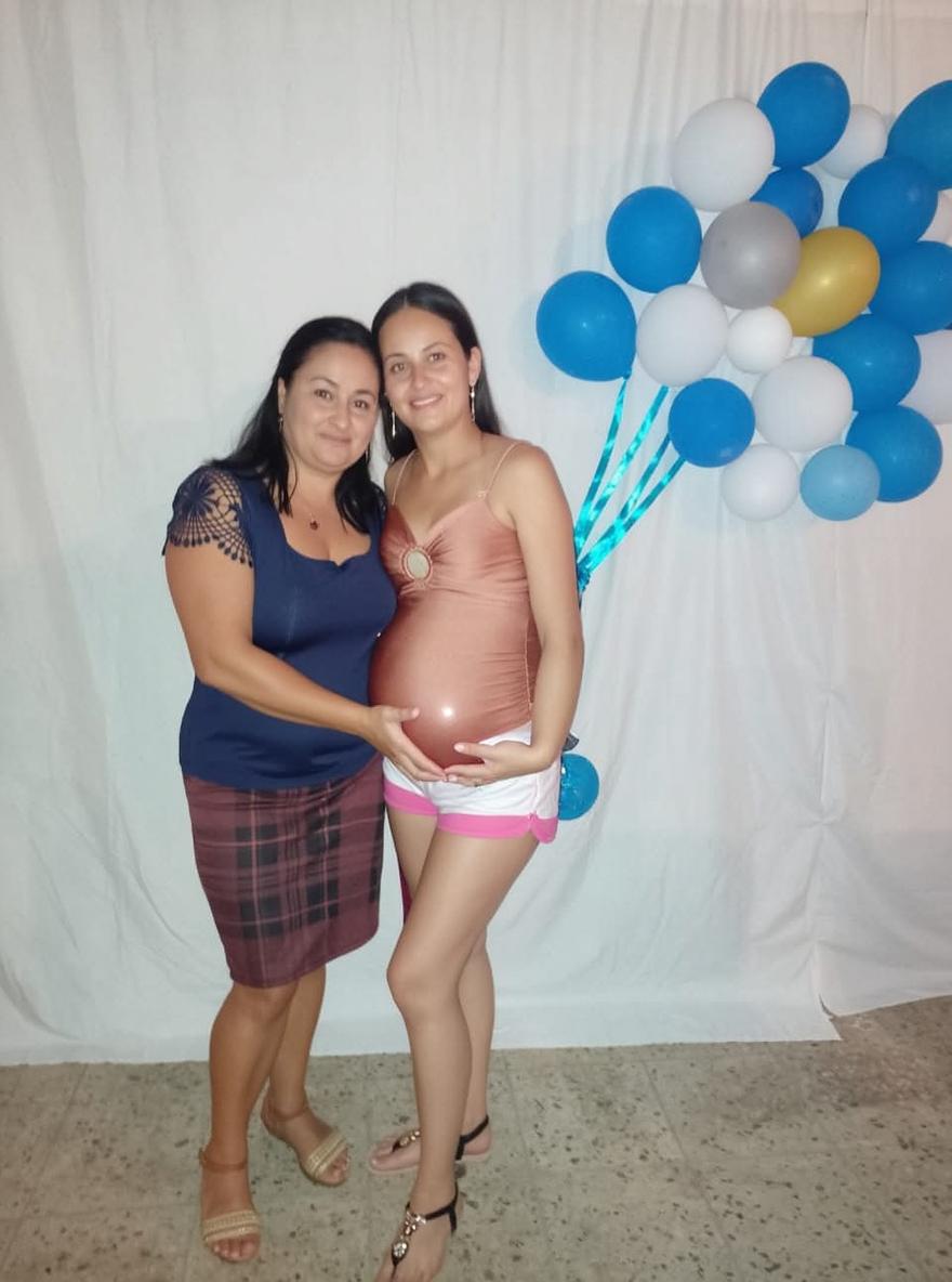 A joyful and intimate moment shared between two women at a celebration