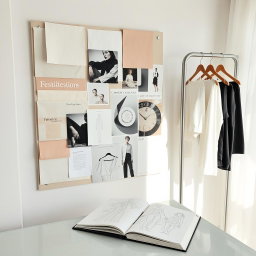 A curated fashion editorial mood board featuring an array of fabric swatches in elegant neutral and pastel tones, artfully pinned to the board