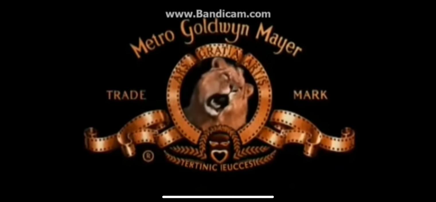 A stylized logo design featuring a majestic lion in a circular emblem, surrounded by elegant vintage film reels, the text 'Metro Goldwyn Mayer' prominently displayed in an artistic font