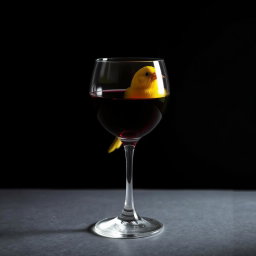 a vivid canary inside a crystal wine glass filled with deep red wine, situated against a dark, moody background, creating a striking contrast, the glass reflecting minimal light to emphasize the richness of the wine, the canary's bright yellow feathers glowing softly in the low light, evoking a sense of intrigue and mystery
