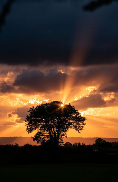 A stunning transformation from darkness to light, featuring a vibrant sunrise breaking through dark clouds, illuminating the sky with hues of orange, pink, and gold