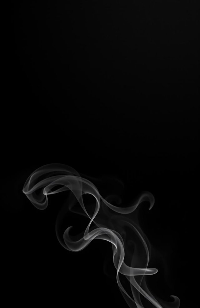 A sleek and shiny black background with an elegant texture, adorned with swirling black and white smoke gracefully rising from the bottom