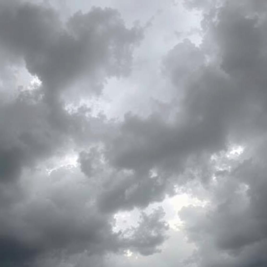 A dramatic and moody sky with clouds in various shades of gray and black, creating a mystical and atmospheric scene