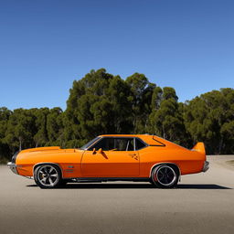 An orange HQ Monaro equipped with a tunnel ram intake system, parked on a wide road with a blue sky in the backdrop