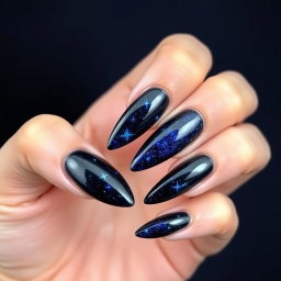 A stunning set of almond-shaped nails with sharp edges, set against a deep navy blue background