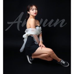 A beautiful Korean woman wearing a strapless top layered with a sheer white jacket, a short black skirt, and sneakers, sitting on the floor sideways while glancing forward gracefully