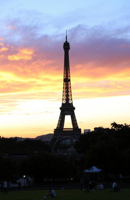 The Eiffel Tower during sunset, showcasing the iconic structure against a dramatically colored sky
