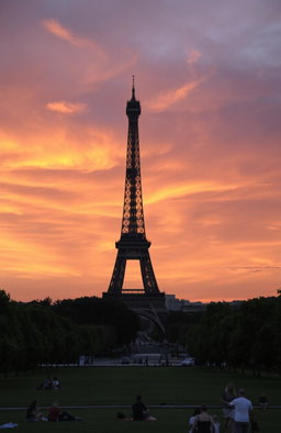 The Eiffel Tower during sunset, showcasing the iconic structure against a dramatically colored sky