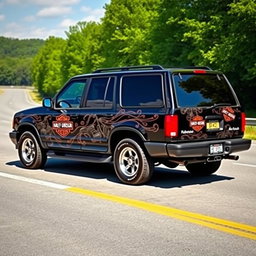 A fully black 1994 Ford Explorer adorned with intricate Harley Davidson designs