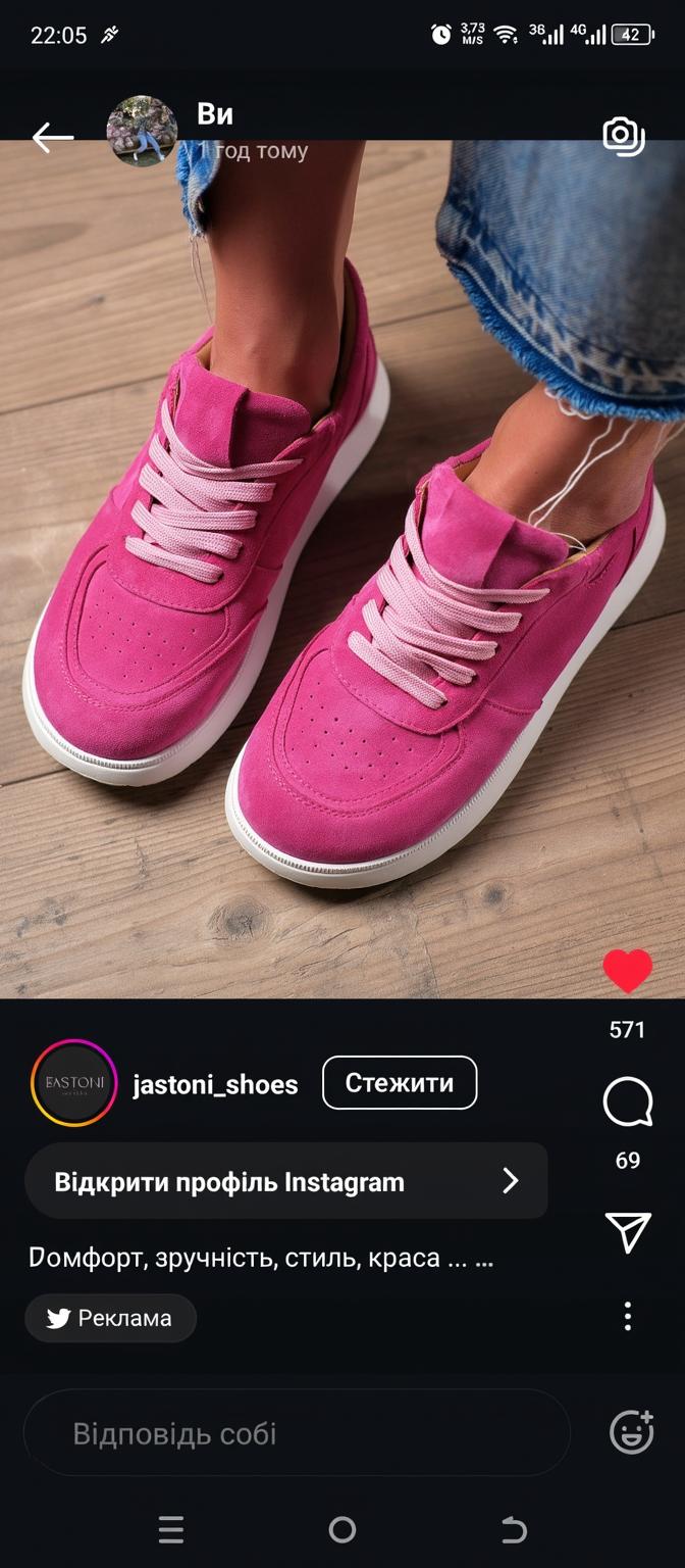 A stylish pair of pink sneakers with a modern design featuring a pink suede upper