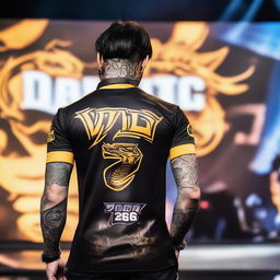 A tattooed man in a dragon-patterned eSports jersey standing on a Mobile Legends stage facing the audience. His back to the camera reveals the name 'QUANTIC', number '25', a dragon logo and the words 'VOID TEAM' on the jersey.