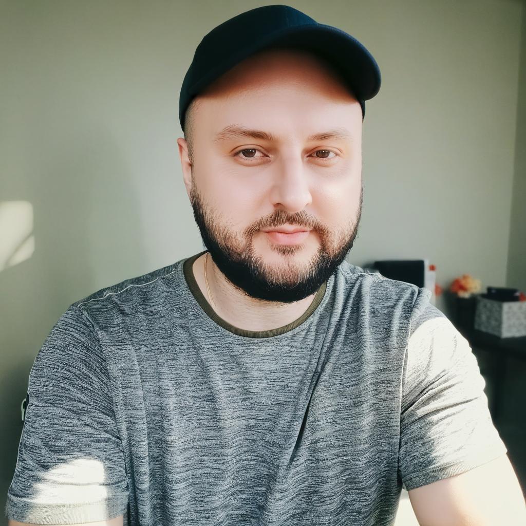 Сделай изображение с этим парнем на фото, где он стоит за прилавком цветочного магазина, вокруг него много различных растений, орхидеи цветущие, папоротники, бромелии, роскошные антуриумы. Все детализированно, создает ощущение сказки. Переодень парня в красивую одежду.