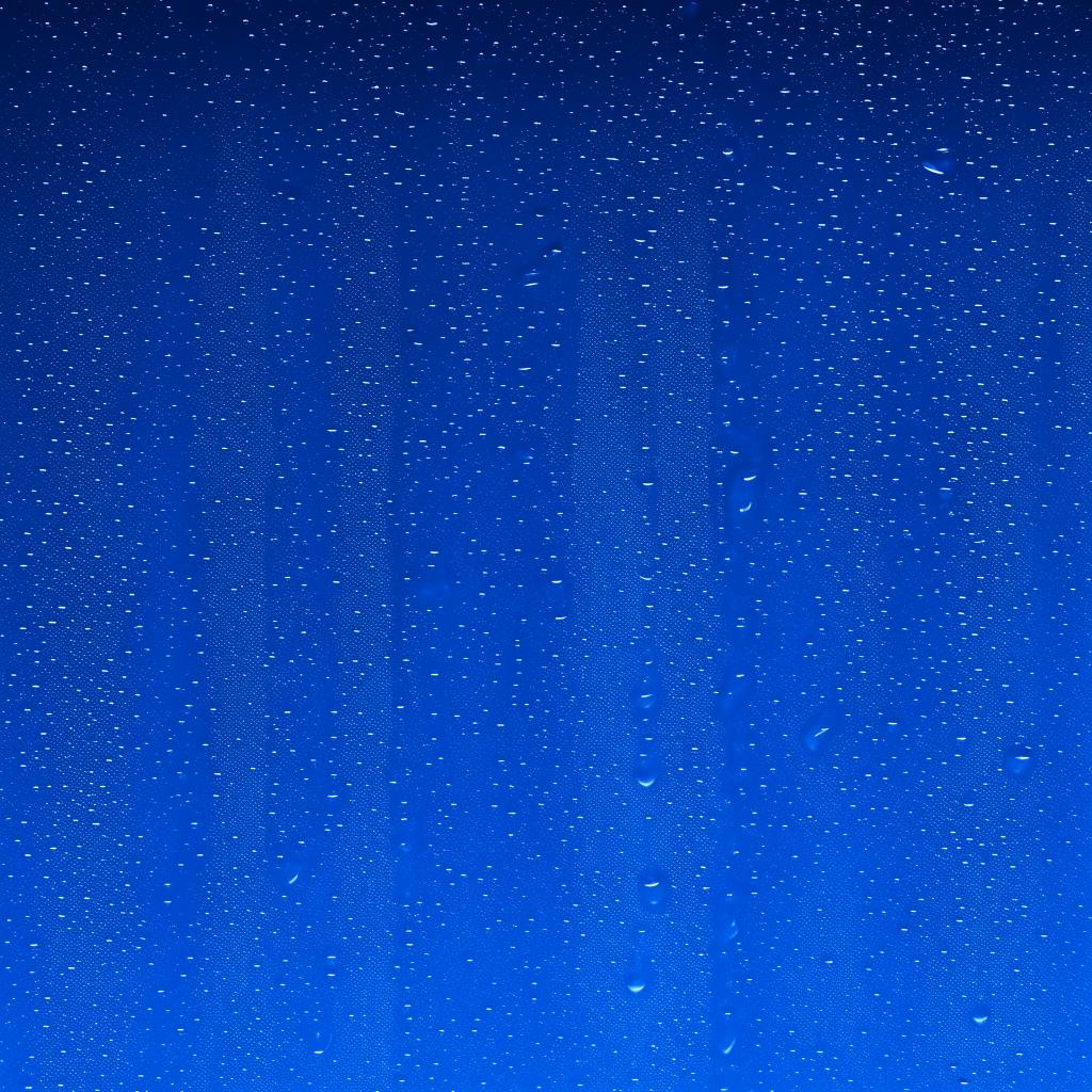 Glistening mineral water droplets cascading down a deep blue background in a 16:9 aspect ratio.