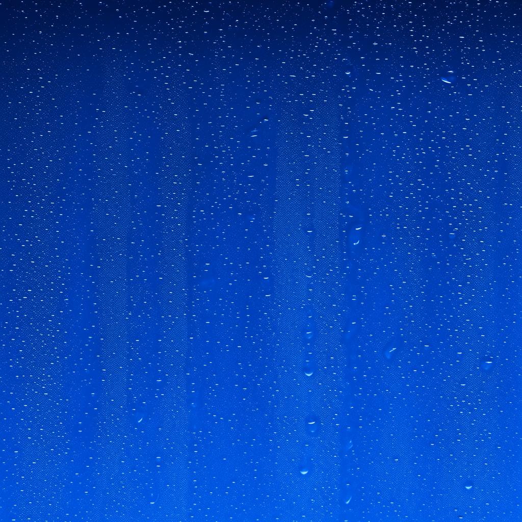 Glistening mineral water droplets cascading down a deep blue background in a 16:9 aspect ratio.