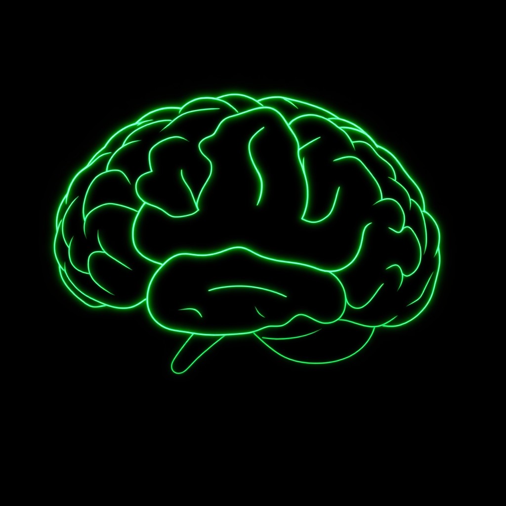 A striking silhouette of a human brain, elegantly outlined in vibrant green neon light against a deep, dark background