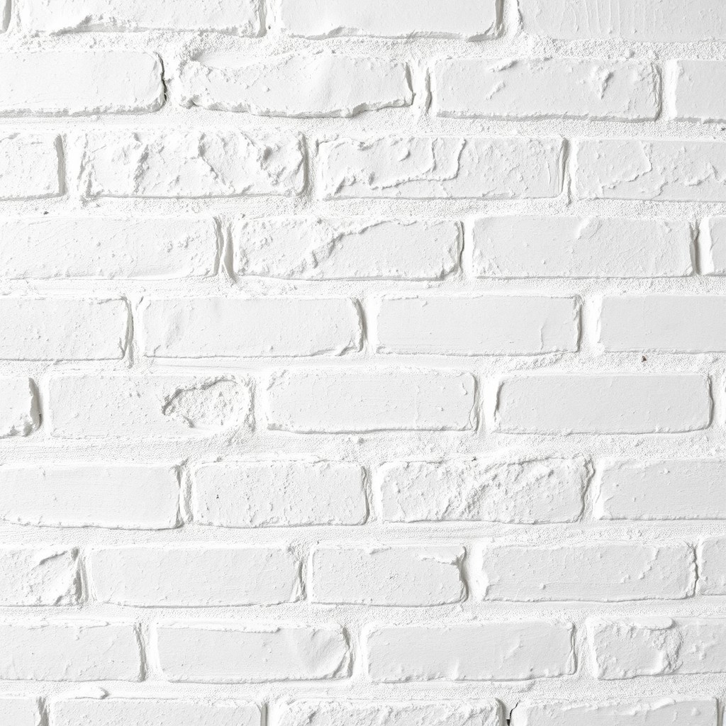 a close-up view of a textured white brick wall, showcasing the subtle variations in shades of white and light gray, natural wear and patina add character, with soft natural lighting creating gentle shadows, ideal for a modern interior design aesthetic