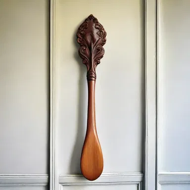 The Victorian-style house had a beautifully carved wooden spanking paddle displayed on the wall as a decorative piece.