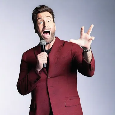During a stand-up comedy show, the comedian surprises the audience with a hilarious punchline they didn't expect, causing them all to burst into laughter.