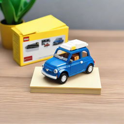 A detailed Lego model of a blue Fiat 500 car placed next to a box on a table.