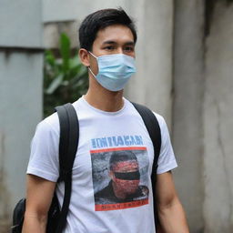 A man in a mask with a backpack, wearing a t-shirt boldly inscribed with 'DNR Rachman'