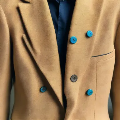 The fashion designer used a scratch awl to mark the precise spots for the buttons on the custom-made jacket.