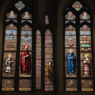 The stained glass windows in the old cathedral created a picturesque scene, portraying religious figures in vibrant colors and intricate detail.