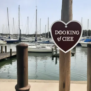 As they strolled along the romantic waterfront, they noticed a sign indicating a docking fee for the sailboats at the marina.